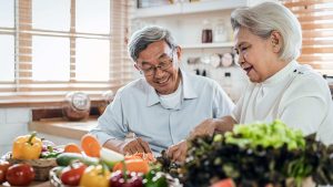 Two old couple enjoying fruits