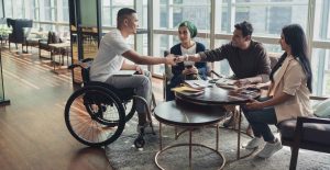 Image about disabled man shaking hand with broker