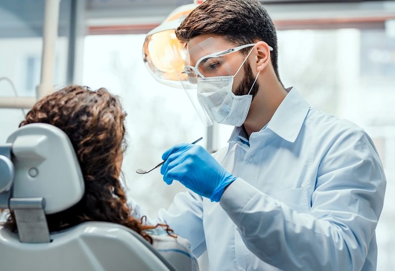 This image is about dentists checking the tooth of patient