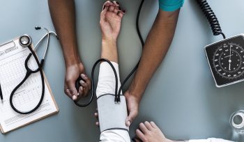 this image about doctor checking bp of patient