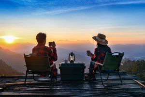 This image about couple sitting watching sunset