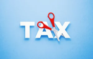 NtMkbYkbmVbQFDVhx5vqEf 1600 80.jpg Can You Get Cancer Insurance for Employees in a Group Plan? The image shows the word "TAX" with a pair of scissors cutting through it