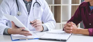 download How Cancer Insurance Helps Employees During Treatment? A doctor discussing something with a patient