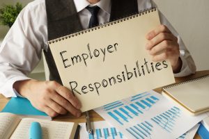 A man holding Employer Responsibilities sign
