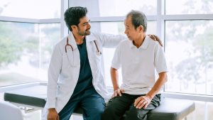 doctor putting hand on the patients shoulder 