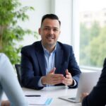 Small business employee benefits broker in Texas meeting with two business owners in a modern office