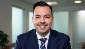 Trey Driver, employee benefits broker at Medcore Brokerage, smiling in an office, ready to help employers shop for group health insurance